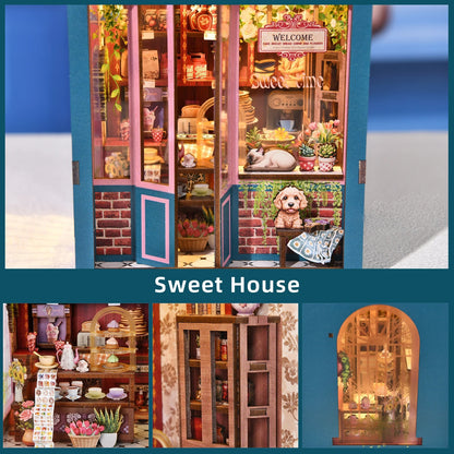 Détails d'un kit book nook Sweet House : devanture de pâtisserie avec chat et chien miniatures, étagère à gâteaux, vaisselle de salon de thé et vue nocturne par la fenêtre. Maquette de boutique romantique en bois.